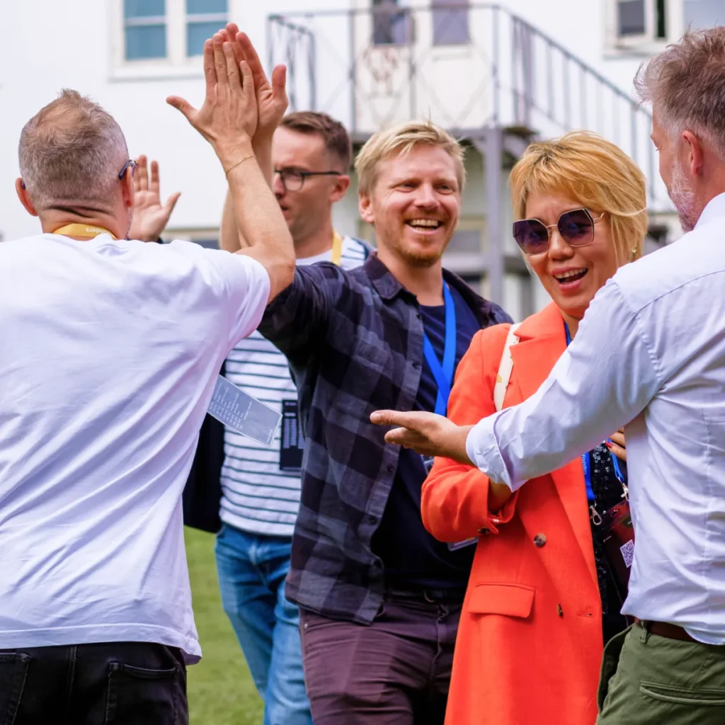 Team celebration with high-five at team building event