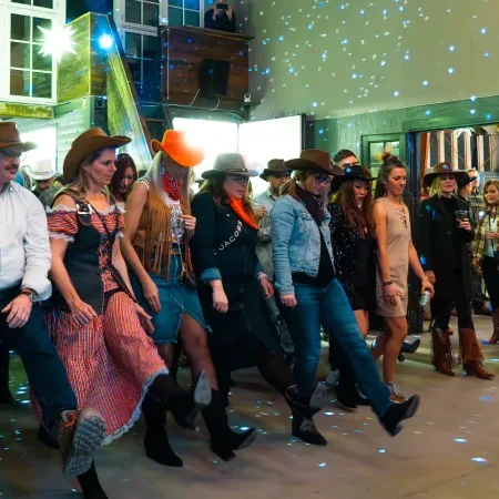 Line dancing entertainment for cowboy-themed company Christmas party in Copenhagen