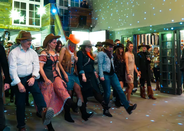 Line dancing entertainment for cowboy-themed company Christmas party in Copenhagen